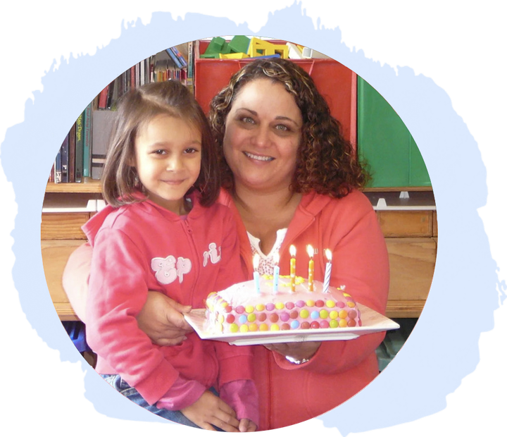 An adult and child sharing a warm birthday moment at A.C.E