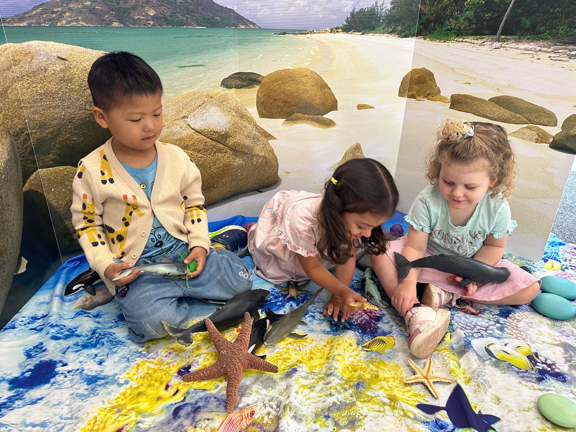 Children collaborating in an imaginative ocean-themed experience at A.C.E