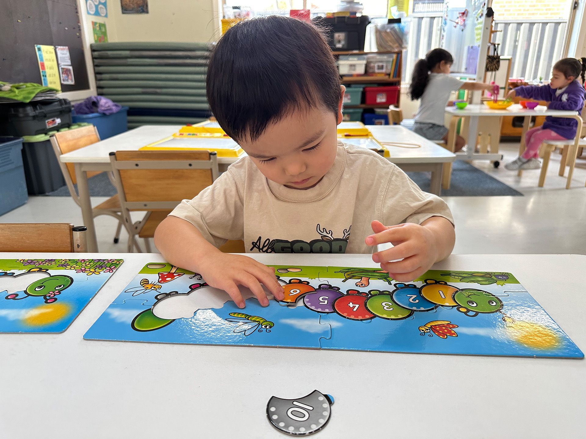 A child concentrating on a number puzzle at A.C.E