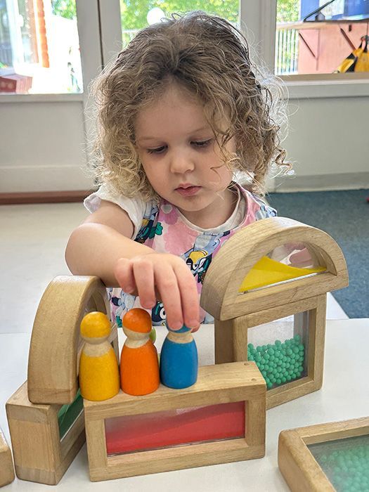 A child absorbed in open-ended play materials