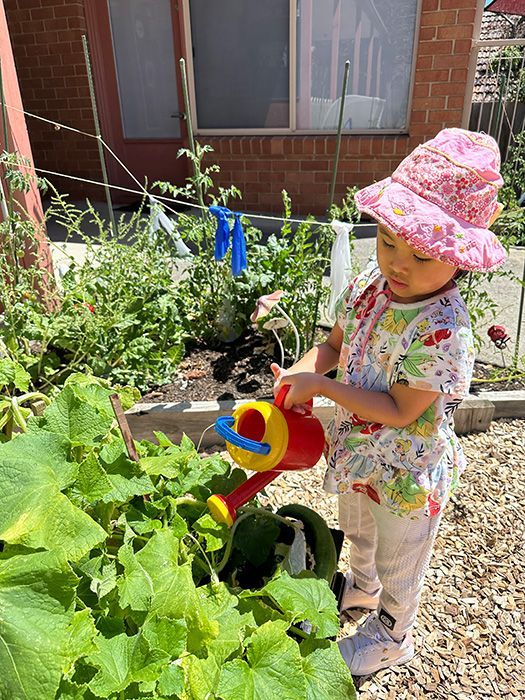 A child caring for vegetables in the A.C.E garden